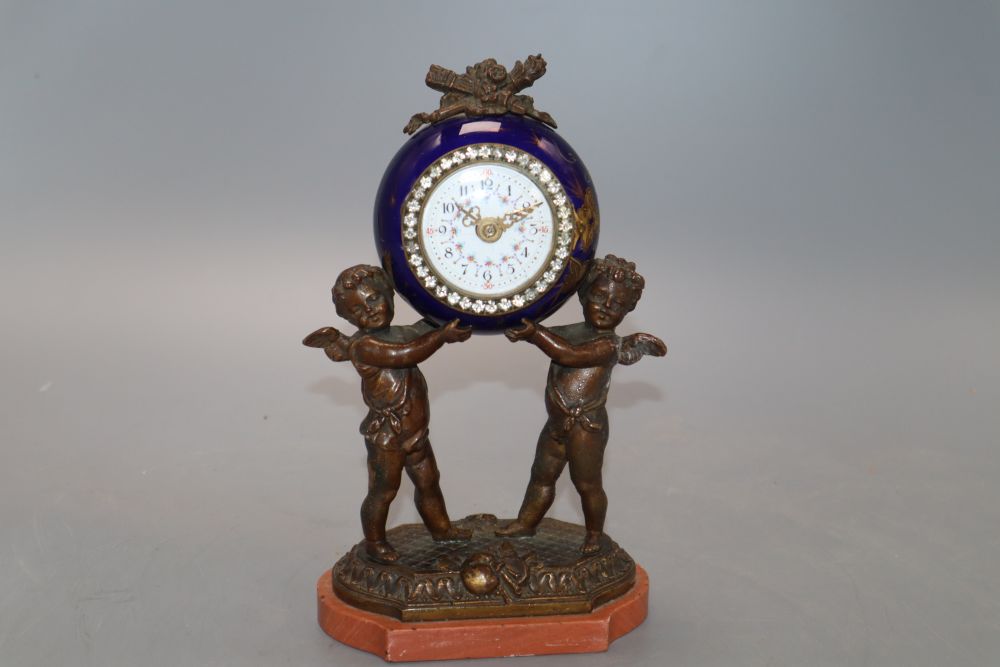 A French porcelain and bronze putti mantel clock, with diamonte decoration to the dial, height 20cm